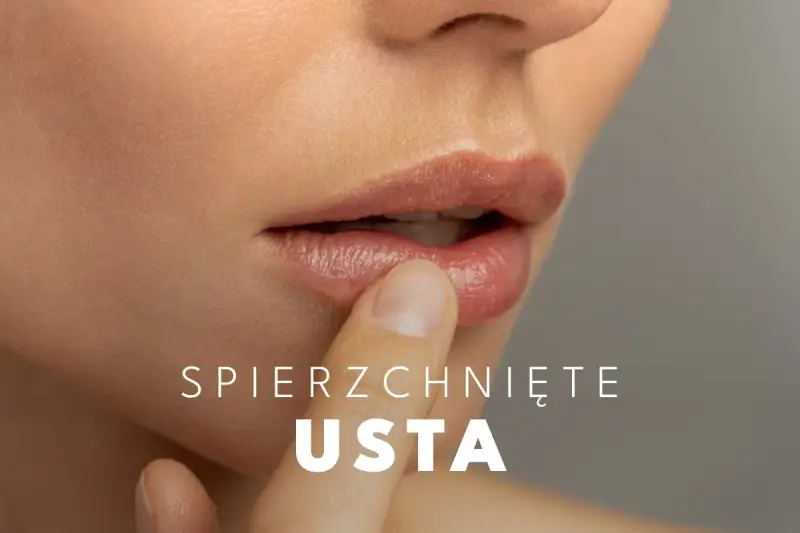 Delikatny dotyk palca na spierzchniętych ustach, szukając ulgi.